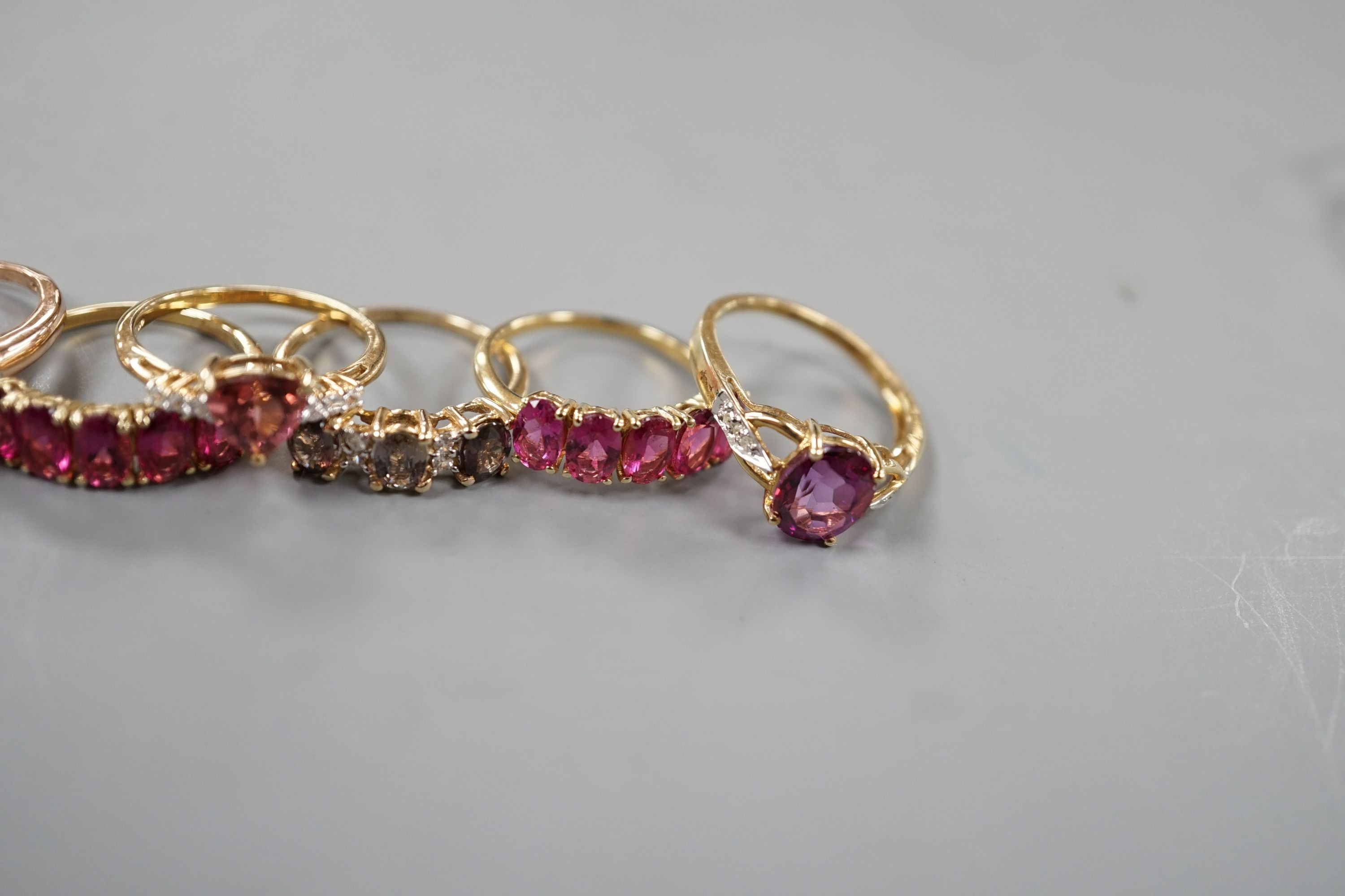 Seven assorted modern 9ct gold and gem set dress rings, including rubellite and a 14ct gold and garnet ring